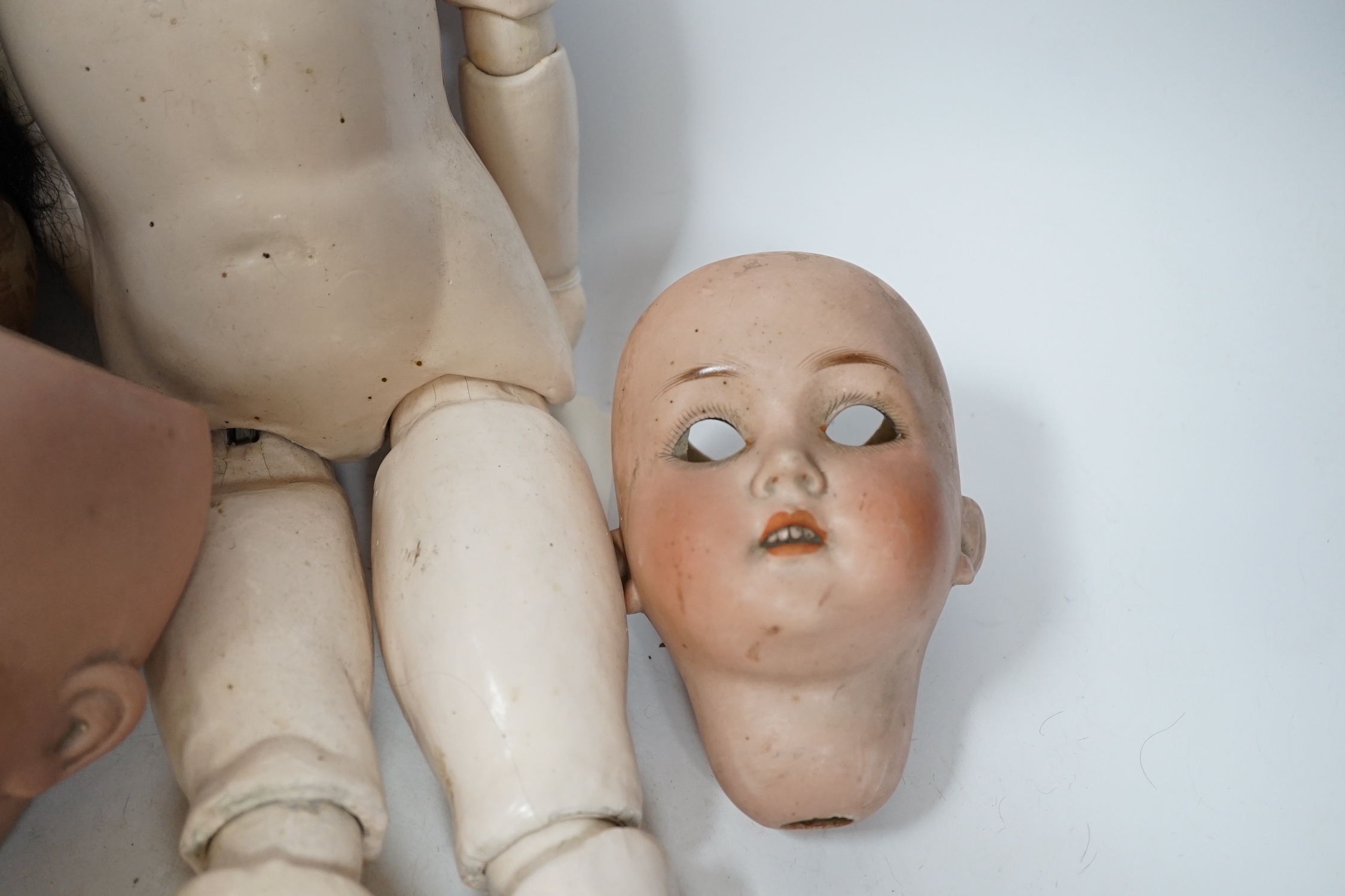 A Heubach doll and five bisque doll’s heads